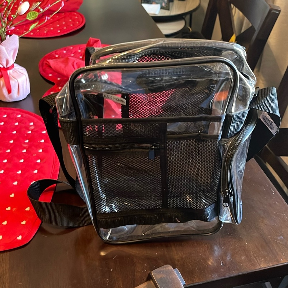 Clear/see through over the shoulder pocket book style bag.
